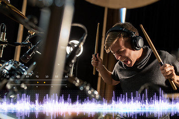 Image showing musician playing drums at sound recording studio