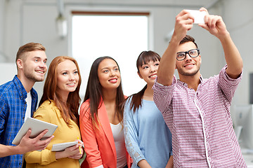 Image showing creative business team taking selfie at office