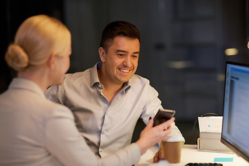 Image showing business people with smartphone at night office