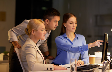 Image showing business team with computer working late at office