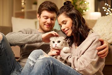 Image showing happy couple with cat at home