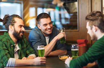 Image showing male friends drinking green beer at bar or pub