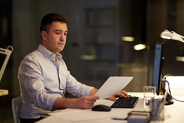 Image showing businessman with computer working at night office