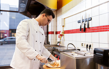 Image showing chef making shawarma wrap with meat at kebab shop