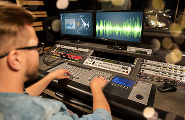 Image showing man at mixing console in music recording studio