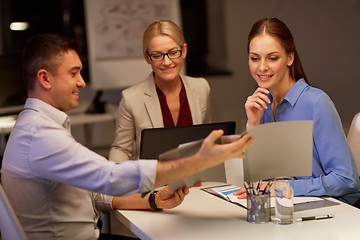 Image showing business team with papers working late at office