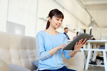 Image showing happy asian woman with tablet pc working at office