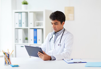 Image showing doctor with tablet pc and stethoscope at clinic