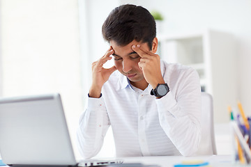 Image showing stressed businessman with laptop at office