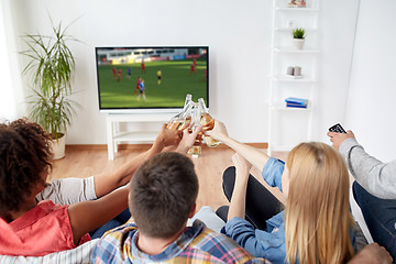 Image showing friends clinking beer and watching soccer game