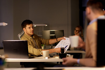 Image showing coworkers with papers working late at office