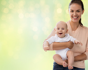 Image showing happy mother with little baby boy over lights