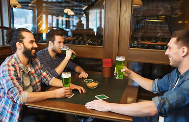 Image showing male friends drinking green beer at bar or pub