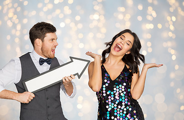 Image showing happy couple with big arrow at party