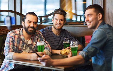 Image showing friends taking selfie with green beer at pub