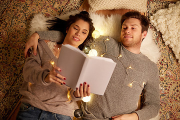 Image showing happy couple reading book at home