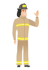 Image showing Young caucasian firefighter waving his hand.