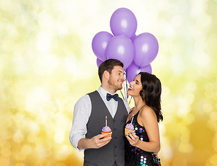 Image showing happy couple with balloons and cupcakes at party