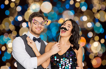 Image showing happy couple with party props having fun