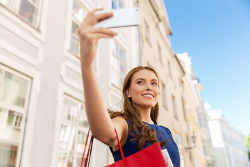Image showing woman shopping and taking selfie by smartphone