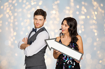 Image showing happy couple with big arrow at party