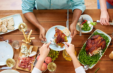 Image showing group of people eating chicken for dinner