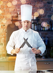 Image showing happy male chef cook in kitchen with knife