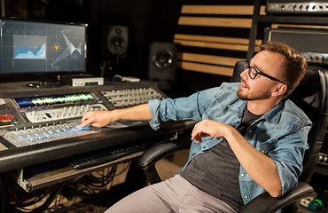 Image showing man at mixing console in music recording studio