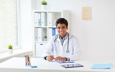 Image showing happy doctor with clipboard at clinic