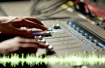 Image showing hands on mixing console in music recording studio