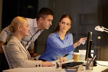 Image showing business team with computer working late at office