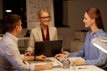 Image showing business team with laptop working late at office