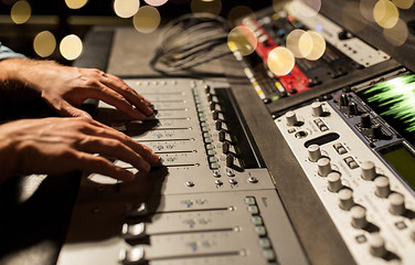 Image showing man using mixing console in music recording studio