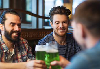 Image showing male friends drinking green beer at bar or pub