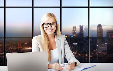 Image showing happy businesswoman with documents at office