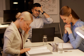 Image showing business team with laptop working late at office