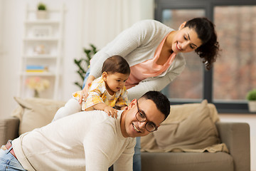 Image showing happy family and baby daughter playing at home