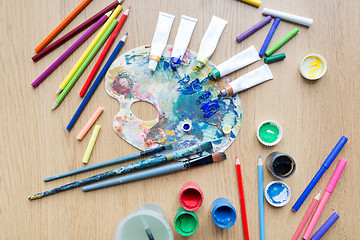 Image showing color palette, brushes and paint tubes on table