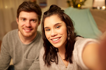 Image showing happy couple taking selfie at home