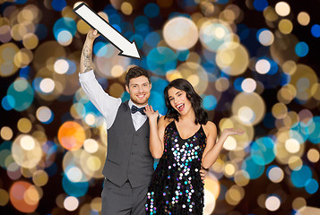 Image showing happy couple with big arrow at party