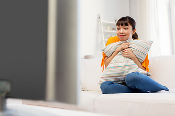 Image showing stunned asian woman with watching tv at home