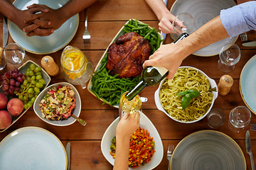 Image showing group of people eating and drinking wine