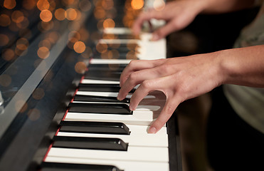 Image showing close up of hands playing piano