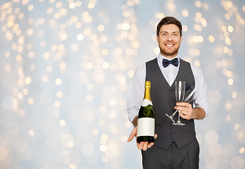 Image showing man with bottle of champagne and glasses at party