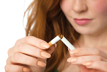 Image showing Young woman is breaking a cigarette