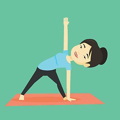 Image showing Woman practicing yoga triangle pose.