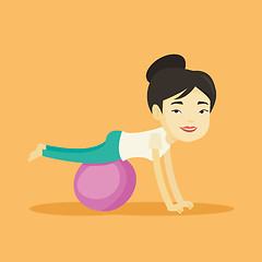 Image showing Young woman exercising with fitball.