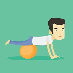 Image showing Young man exercising with fitball.