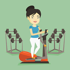 Image showing Woman exercising on elliptical trainer.