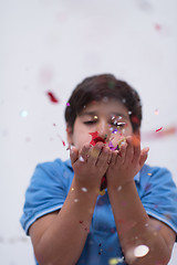 Image showing kid blowing confetti